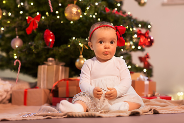 Image showing baby girl at christmas tree with gifts at home