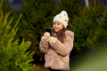 Image showing girl with smartphone at christmas tree market