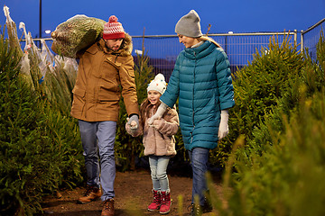 Image showing happy family buying christmas tree at market