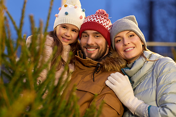 Image showing happy family choosing christmas tree at market