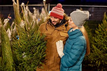 Image showing happy couple buying christmas tree at market