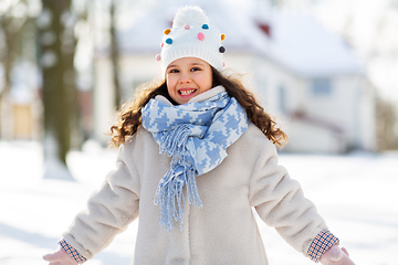 Image showing happy little girl in winter clothes outdoors