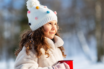 Image showing little girl with cup of hot tea in winter park