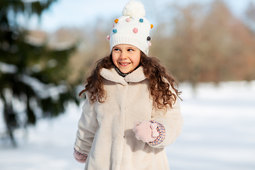 Image showing happy little girl in winter clothes outdoors