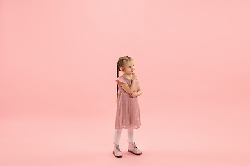 Image showing Childhood and dream about big and famous future. Pretty longhair girl isolated on coral pink background