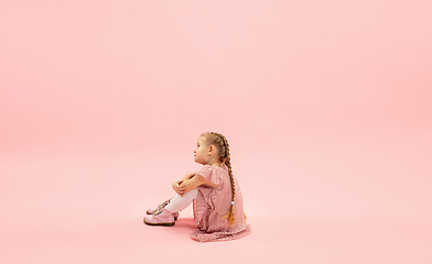 Image showing Childhood and dream about big and famous future. Pretty longhair girl isolated on coral pink background