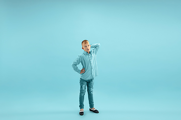 Image showing Childhood and dream about big and famous future. Pretty little boy isolated on blue background