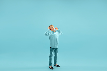 Image showing Childhood and dream about big and famous future. Pretty little boy isolated on blue background