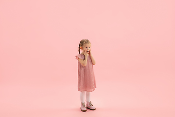 Image showing Childhood and dream about big and famous future. Pretty longhair girl isolated on coral pink background