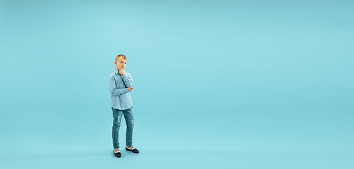 Image showing Childhood and dream about big and famous future. Pretty little boy isolated on blue background