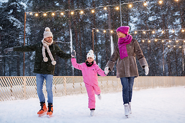 Image showing happy family at outdoor skating rink in winter