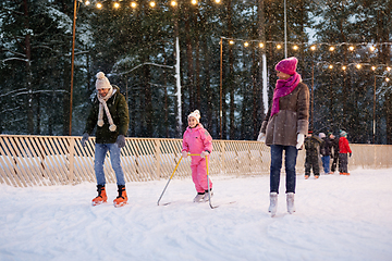 Image showing happy family at outdoor skating rink in winter