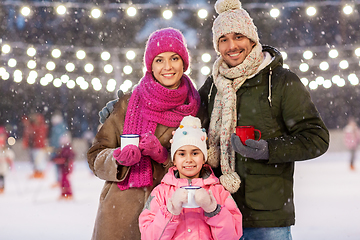 Image showing happy family drinking hot tea on skating rink