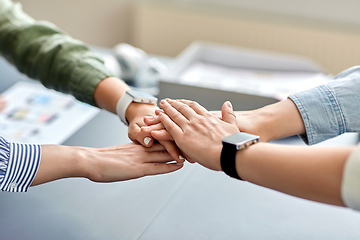 Image showing close up of business team stacking hands