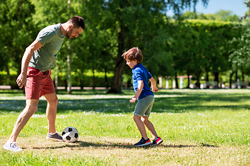 Image showing father with little son playing soccer at park