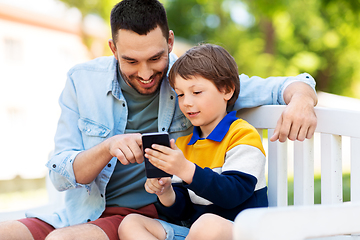 Image showing father and son with smartphone at park