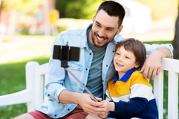 Image showing father and son taking selfie with phone at park