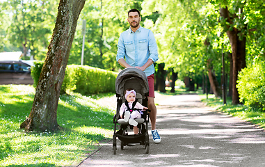 Image showing happy father with child in stroller at summer park