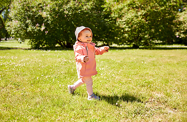 Image showing happy little baby girl walking at park in summer