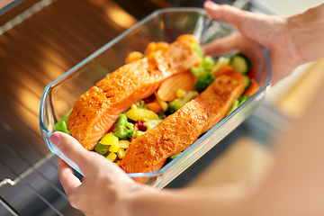 Image showing woman cooking food in oven at home kitchen