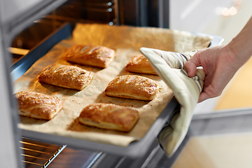 Image showing woman cooking food in oven at home kitchen