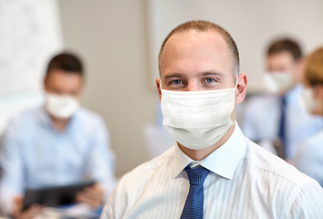 Image showing businessman wearing face protective mask at office