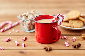 Image showing cup of eggnog with candy cane, cookies and sugar