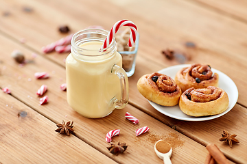 Image showing eggnog with candy cane in mug and cinnamon buns