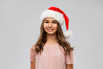 Image showing happy teenage girl in santa hat on christmas