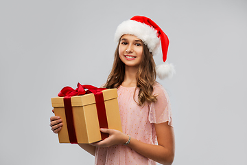 Image showing teenage girl in santa hat with christmas gift