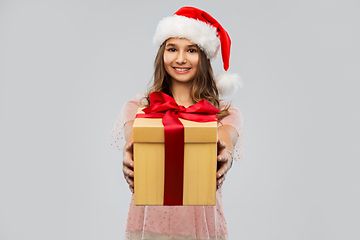 Image showing teenage girl in santa hat with christmas gift