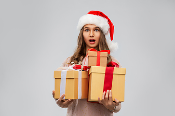 Image showing teenage girl in santa hat with christmas gift