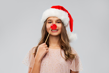 Image showing happy teenage girl in santa hat on christmas