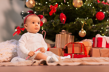 Image showing baby girl at christmas tree with gifts at home