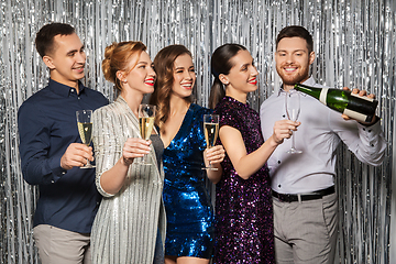 Image showing friends pouring champagne to glasses at party