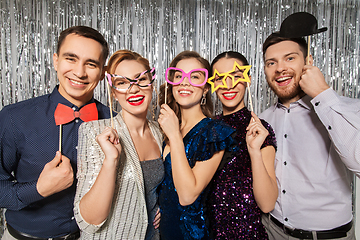 Image showing happy friends posing with party props