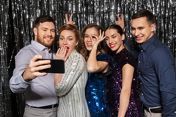 Image showing happy friends taking selfie by smartphone at party