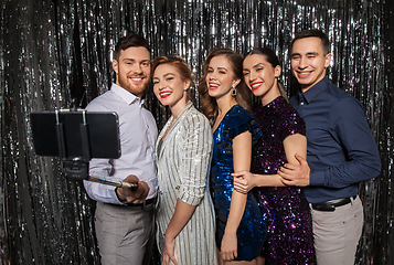 Image showing happy friends taking selfie by smartphone at party