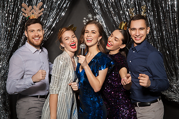 Image showing friends with microphone singing at christmas party