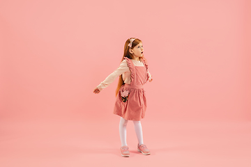 Image showing Childhood and dream about big and famous future. Pretty longhair girl isolated on coral pink background