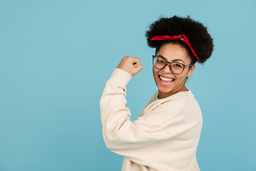 Image showing African-american woman\'s portrait isolated on blue studio background with copyspace