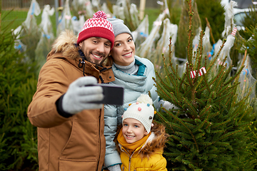 Image showing family taking selfie with christmas tree at market