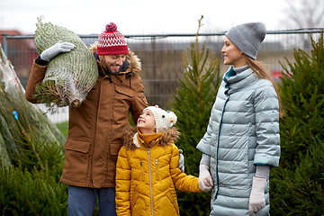 Image showing happy family buying christmas tree at market