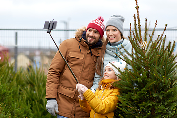 Image showing family taking selfie with christmas tree at market