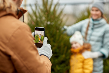 Image showing family taking picture of christmas tree at market