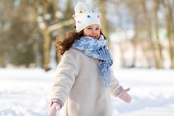 Image showing happy little girl in winter clothes outdoors