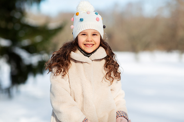 Image showing happy little girl in winter clothes outdoors