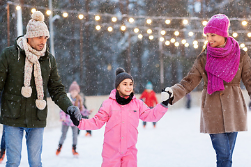 Image showing happy family at outdoor skating rink in winter