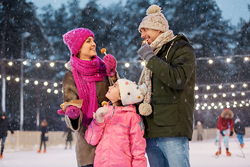 Image showing happy family eating pancakes on skating rink