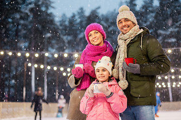 Image showing happy family drinking hot tea on skating rink